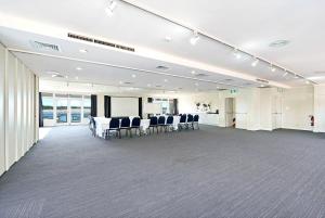 a large room with chairs and tables in it at Comfort Resort Waters Edge in Port Macquarie +61 photos