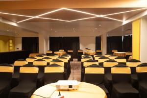 a conference room with rows of tables and chairs at Magnus Lxia Premier, Kalyani Nagar Pune in Pune