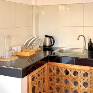 a kitchen with a sink and a counter top at Brisa Room T in El Nido Airport