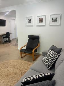 a living room with a couch and a chair at Somerset Palms Studio Apartment in Horseshoe Bay