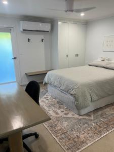 a bedroom with a bed and a desk and a table at Somerset Palms Studio Apartment in Horseshoe Bay +53 photos