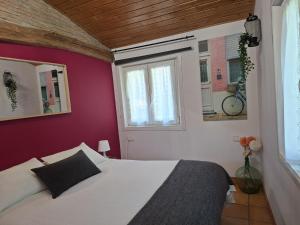 a bedroom with a white bed and a window at ANTZOMENDI in Mutriku