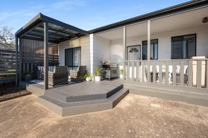 a house with a deck with a grill on it at Charming CBD cottage - walk everywhere in Mount Gambier