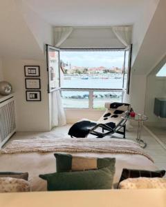 a bedroom with a bed and a large window at Apartamento Platas Centro in Ribadesella