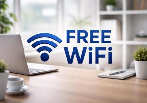 a free wifi sign on a desk with a laptop at PAULINEN Residenz Komfortabel wohnen - Flexibel ankommen in Detmold