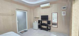 a living room with a television and a room with a door at Rimpuhill resort in Sattahip +51 photos