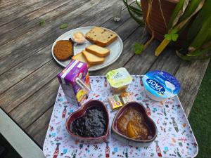 a table with a plate of food on a table at Chez damdam et titi in Dijon