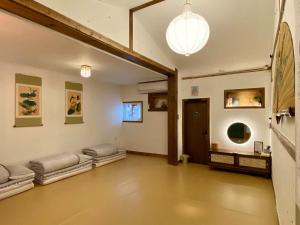 a large room with several beds on the wall at Architect's Cat Hanok - Sindal House Gyeongju in Gyeongju