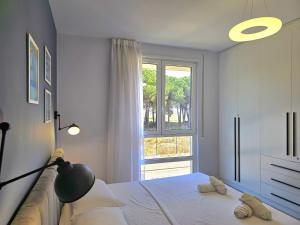 a bedroom with a bed and a large window at White Moon Apartment 301 in Lalzit Bay