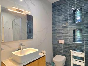 a bathroom with a sink and a toilet at White Moon Apartment 301 in Lalzit Bay +44 photos