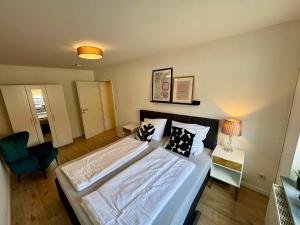 a bedroom with a large bed with pillows on it at Schkeuditz Gästeapartment II in Schkeuditz
