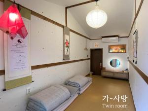 a room with two beds in a room at Architect's Cat Hanok - Sindal House Gyeongju in Gyeongju