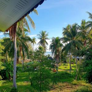 a view of the ocean from a resort with palm trees at Mangrove Beach Houses in Srithanu +46 photos