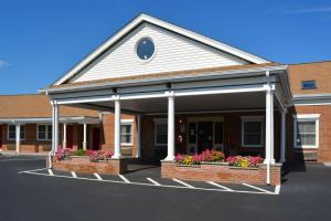a building with two flower boxes in front of it at Quality Inn Raynham - Taunton in Raynham