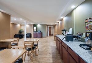 a restaurant with tables and chairs and a cafeteria at Quality Inn Near Pimlico Racetrack in Baltimore