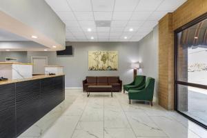 a waiting room with a couch and a chair at Quality Inn Columbus, MS in Columbus