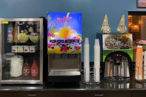 a counter with an open refrigerator and a drink dispenser at Quality Inn Kenly I-95 in Kenly