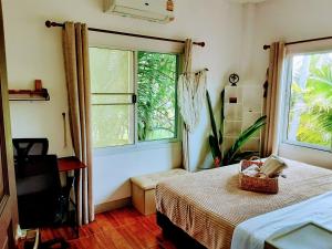a bedroom with a bed with a basket on it at Mangrove Beach Houses in Srithanu