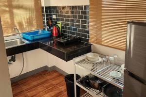 a small kitchen with a sink and a counter top at Mangrove Beach Houses in Srithanu