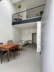 a living room with a table and a staircase at Modern Loft mit Terrasse in Vienna