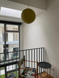 a room with a balcony with a table and a lamp at Modern Loft mit Terrasse in Vienna +18 photos