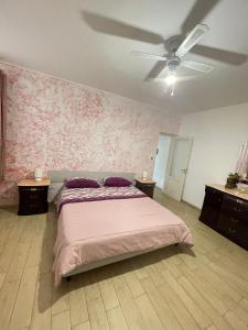 a bedroom with a bed and a ceiling fan at Villa Coco Monopoli in Monopoli +29 photos