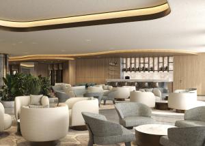 a hotel lobby with chairs and tables and a bar at Merit Crystal Cove Hotel Casino & SPA in Kyrenia +1 photo
