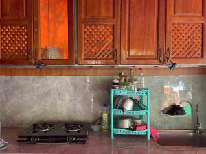 a kitchen with a blue shelf next to a stove at Sống Chill Homestay in Nam Yên +38 photos