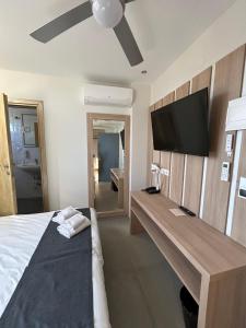 a bedroom with a bed and a flat screen tv at Perea Hotel in Perea