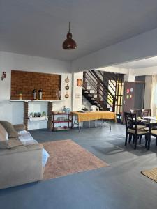 a living room with a couch and a table at Casa Cochilo na Rede in Beberibe