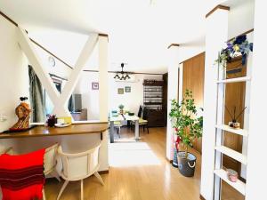 a living room with a table and a dining room at 清場Kiyoba in Kawaguchi