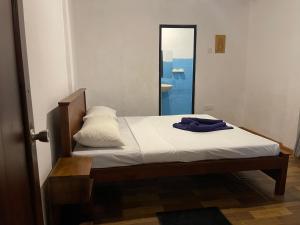 a bed in a room with a mirror at Coconut beach in Bentota
