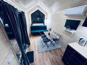 an overhead view of a living room with a couch and chairs at Stockholm Archipelago by Tiny Away in Fagerdala