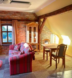 a living room with a couch and a table at Falkenwohnung in Gommern