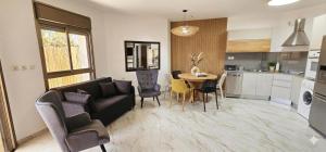 a living room with a couch and a table at Amdar Holiday Apartments in Eilat