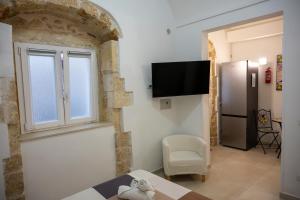 a living room with a refrigerator and a window at Kalsa’s House Noto in Noto