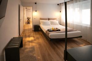 a bedroom with a bed with a tray of food on it at Residenza Ximenes Hub in Palermo