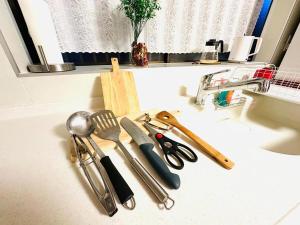 a kitchen counter with utensils and a sink at 清場Kiyoba in Kawaguchi +61 photos
