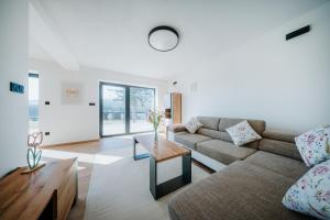 a living room with a couch and a table at Kotva By Momoland - Apartmán in Ružiná
