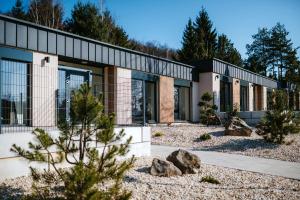 a rendering of a building with trees and rocks at Kotva By Momoland - Apartmán in Ružiná
