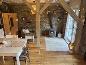 a living room with a stone wall and a wood stove at Stodola Jankovna in Skuhrov +39 photos