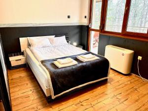 a bedroom with a bed with two towels on it at Villa Amity in Varna City +47 photos