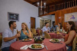a group of people sitting around a table in a restaurant at Hotel 1492 in San José +18 photos