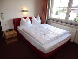 Postel nebo postele na pokoji v ubytování Hotel Weserschiffchen