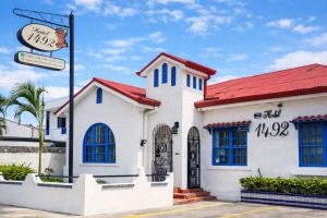 a white church with a red roof at Hotel 1492 in San José