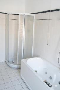 a white bathroom with a tub and a shower at Hotel Villa Furia in Bellaria-Igea Marina +21 photos