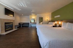 a hotel room with two beds and a fireplace at Fisherman's Cove Inn in Monterey