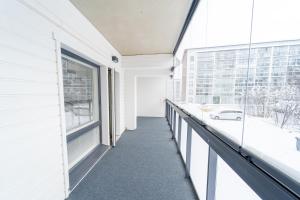 a balcony of a white building with a window at Snowflake XII Family rooms in Rovaniemi