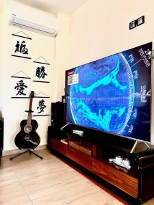 a living room with a flat screen tv and a guitar at Villa Amity in Varna City