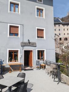 a patio with tables and chairs in front of a building at Casa Elena in Casso +7 photos